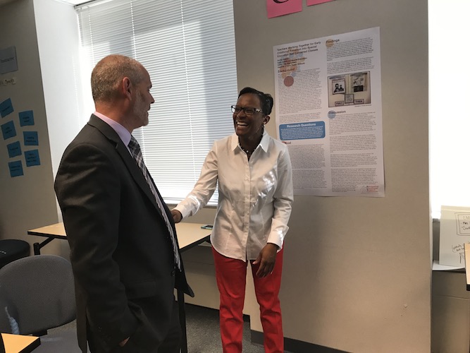 Teacher Researcher, Solitia Wilson (Hanover) sharing her poster with Mark Beckett, Principal of Chickahominy Middle School